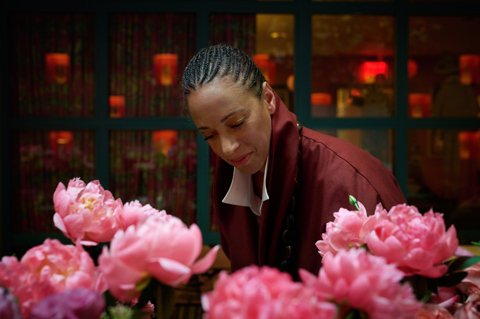 Shot of floral designer Tawana Schlegel with some bright pink flowers