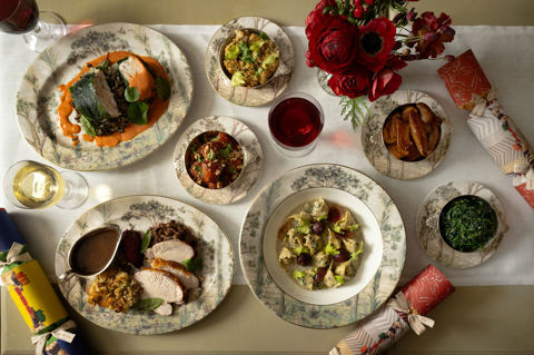 This a landscape image from above of a festive dining scene at the Warren Street Bar, Warren Street Hotel, featuring different dishes from the festive menu including a seasonal pasta dish and a traditional roast dinner served on Tall Tress Fine Bone China.