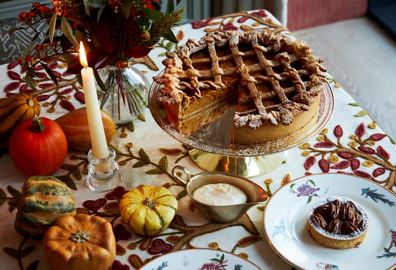 Pecan pie with a slice missing and smaller version on a plate next to it