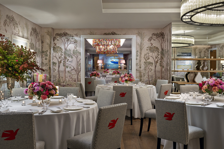 Round dining tables set-up in the Prince private events room looking over the Spring room at Crosby Street Hotel