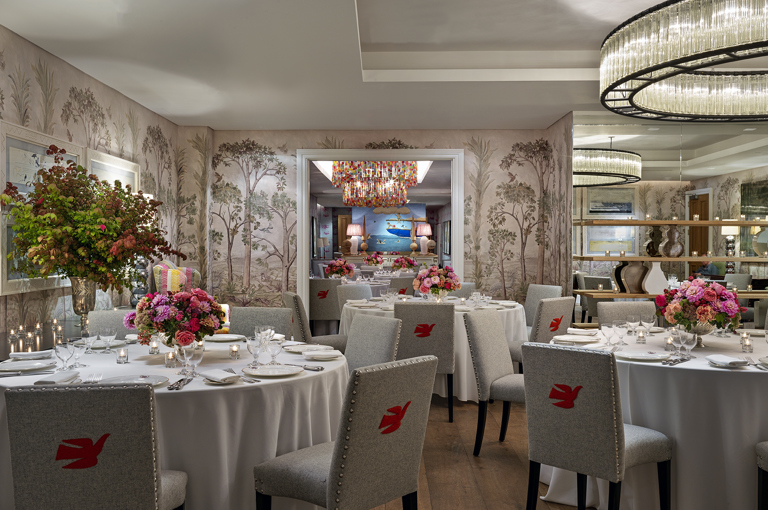 Round dining tables set-up in the Prince private events room looking over the Spring room at Crosby Street Hotel