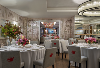 Round dining tables set-up in the Prince private events room looking over the Spring room at Crosby Street Hotel